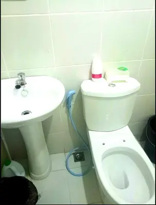 a bathroom with a toilet and a sink at Condo Transient Near NAIA Airport-Unlimited Internet v2 in Manila