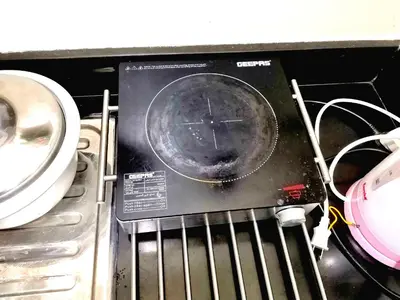 a clock sitting on top of a stove at Condo Transient Near NAIA Airport-Unlimited Internet v2 in Manila