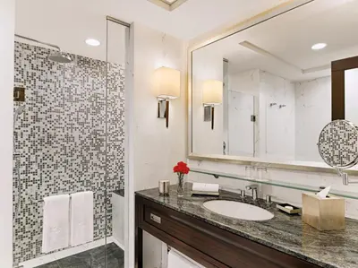a bathroom with a sink and a mirror at Quest Plus Filinvest City Manila in Manila