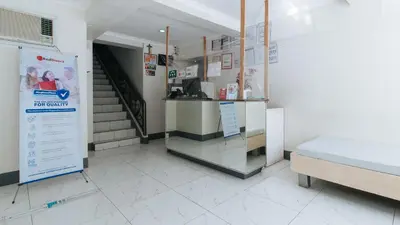 a hospital room with a bed and a counter at RedDoorz at Samat Mandaluyong in Manila
