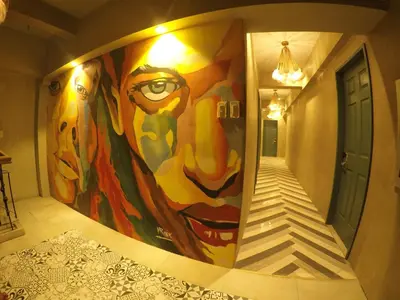 a large painting on the wall in a hallway at Citizen Hotel in Manila
