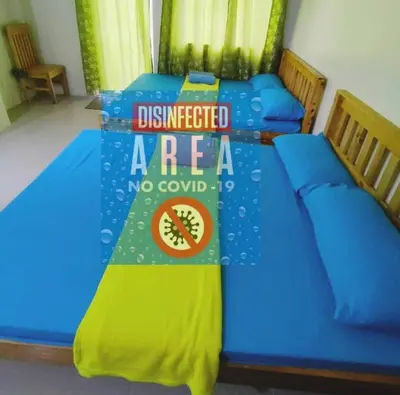 two beds in a room with a sign that readsaffected area at Condo Transient Near NAIA Airport T1234 with Unlimited WIFI v1 in Manila