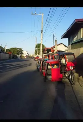 a row of vehicles parked on the side of a street at Estien's cozy home in Malagasang Primero