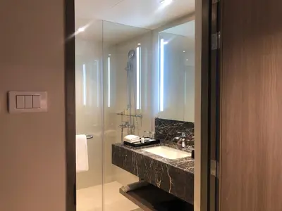 a bathroom with a sink and a mirror at Seda Residences Makati in Manila