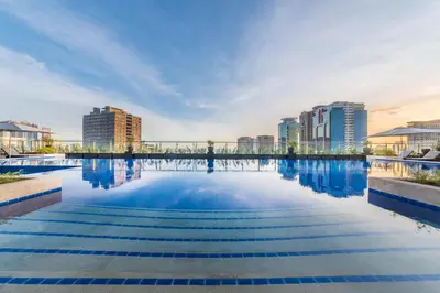 a swimming pool in a city with buildings at Seda Residences Makati in Manila