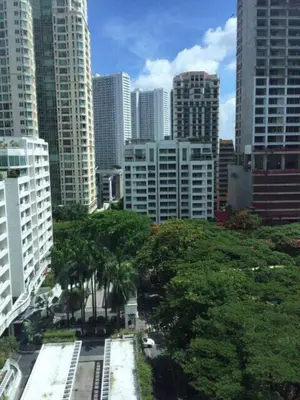 a view of a city with tall buildings and trees at Affordable Cozy Pad in Salcedo Village Makati in Manila