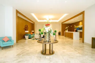 a lobby with a table with flowers on it at Hotel Lucky Chinatown Binondo Manila in Manila