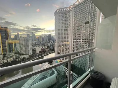a view of a city from a balcony of a building at Great 1BR Aqua Livingstone with Netflix, Pool & Gym in Manila