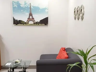a living room with a couch and the eiffel tower at Jen's Paranaque City Apartment in Manila