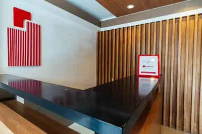 a table with a red sign on a wall at Urban Deca Tower OYO 3 in Manila