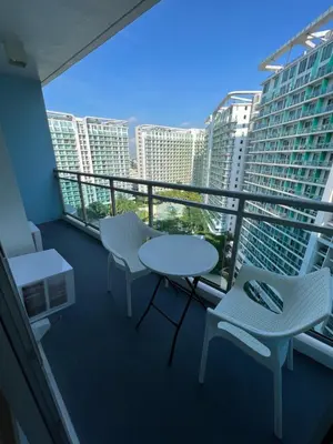 a balcony with two chairs and a table and chairs at AZURE URBAN RESORT RESIDENCE R&C - Parañaque in Manila