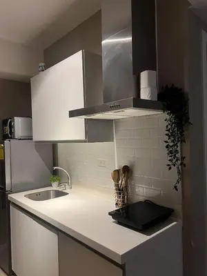 a kitchen with white cabinets and a sink at AZURE URBAN RESORT RESIDENCE R&C - Parañaque in Manila