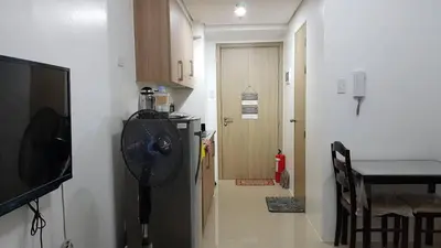 a room with a hallway with a fan and a kitchen at 1 Bedroom Apartment @SMDC Shore Residences, Mall of Asia in Manila