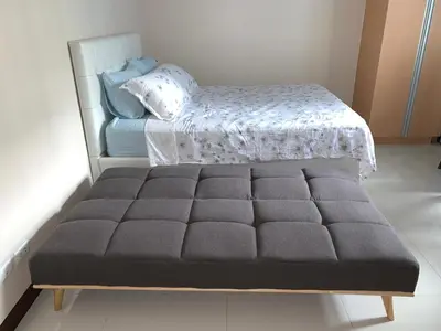 a bed sitting in a bedroom next to a bed sidx sidx sidx at 101 Newport City Chillax C2 Manila Airport Pasay in Manila