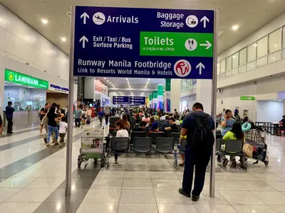 a man standing in a shopping mall with a sign at 101 Newport City Chillax C2 Manila Airport Pasay in Manila