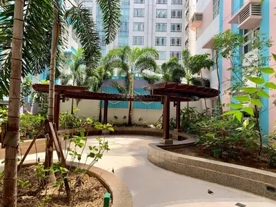 a garden with a wooden pergola in front of a building at 101 Newport City Chillax C2 Manila Airport Pasay in Manila