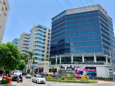 a large glass building with cars parked in front of it at 101 Newport City Chillax C2 Manila Airport Pasay in Manila