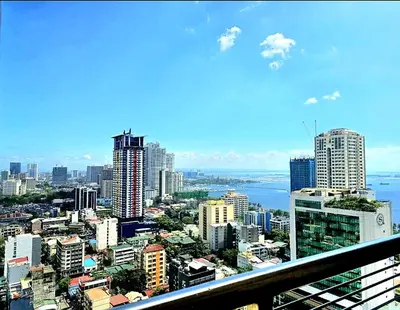 a view of a city from a balcony at JMM Grand Suites in Manila
