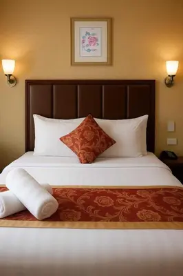 a bedroom with a large bed with white sheets and pillows at JMM Grand Suites in Manila