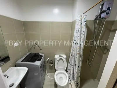 a small bathroom with a toilet and a sink at Shore Residences, Mall Of Asia Complex Stays by PBYY in Manila