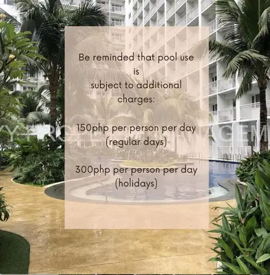a sign in front of a building with palm trees at Shore Residences, Mall Of Asia Complex Stays by PBYY in Manila