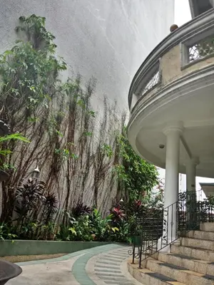 a wall of plants in a building with stairs at Casa Micarosa Hotel in Manila