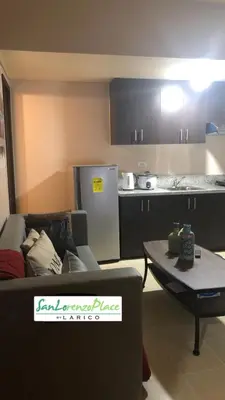 a living room with a couch and a table at SAN LORENZO PLACE 2BR 29-E by LARICO in Manila