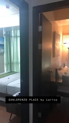 a reflection of a bedroom with a bed in a mirror at SAN LORENZO PLACE 2BR 29-E by LARICO in Manila