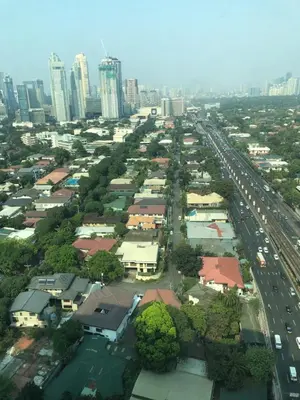 an aerial view of a city with buildings and cars at SAN LORENZO PLACE 2BR 29-E by LARICO in Manila