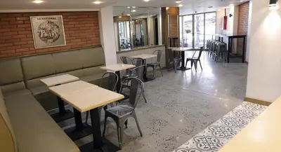 a row of tables and chairs in a restaurant at 1010 Hotel in Manila