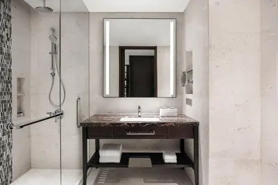 a bathroom with a sink and a mirror at Sheraton Manila Hotel at Newport World Resorts in Manila