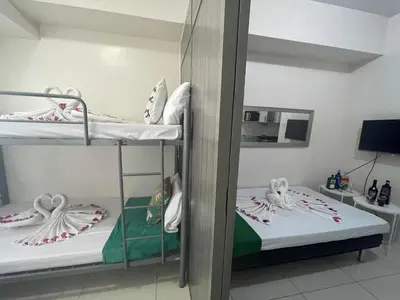 a couple of bunk beds in a room at Green Residences Stays by PBYY in Manila
