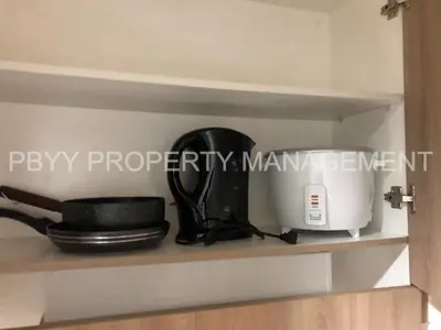 a kitchen shelf with a coffee maker and a appliance at Shore Residences, Mall Of Asia Complex Stayction by PBYY in Manila