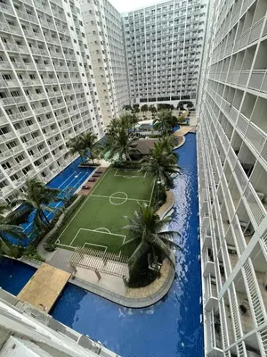 an aerial view of a courtyard between two tall buildings at Shore Residences, Mall Of Asia Complex Stayction by PBYY in Manila