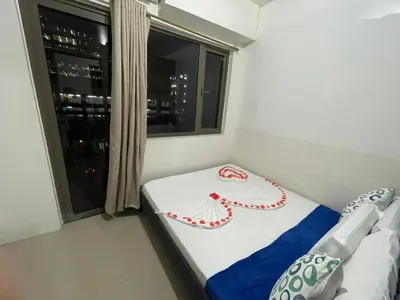 a small bedroom with a bed and a window at Shore Residences, Mall Of Asia Complex Stayction by PBYY in Manila