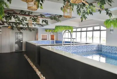 two large pools with blue tiles in a large room at Selah Lofts Hotel in Manila