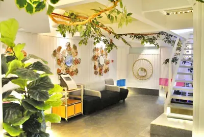 a living room with a couch and a plant at Selah Lofts Hotel in Manila