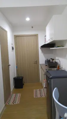 a small kitchen with a door and a counter top at 1BR Grace Residences w/ Internet- near BGC/McKinley in Manila