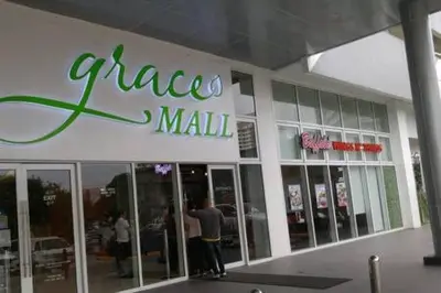 a man standing in front of a pizza mall at 1BR Grace Residences w/ Internet- near BGC/McKinley in Manila