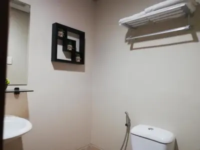 a bathroom with a white toilet and a sink at Cozy Staycation at Eastbay Residences in Manila