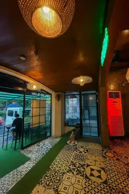 a lobby of a building with a person sitting at a table at CONNECTOR Hostel in Manila
