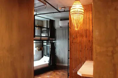a room with two bunk beds and a chandelier at CONNECTOR Hostel in Manila