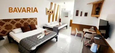 a bedroom with a bed with two dogs laying on it at ROCCA Del GARDA Residences in Binangonan