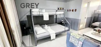 a bedroom with two bunk beds in a room at ROCCA Del GARDA Residences in Binangonan