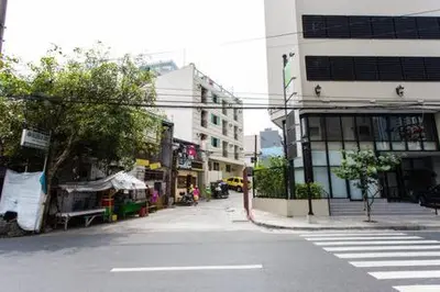 an empty street in a city with a building at San Agustin Residences in Manila