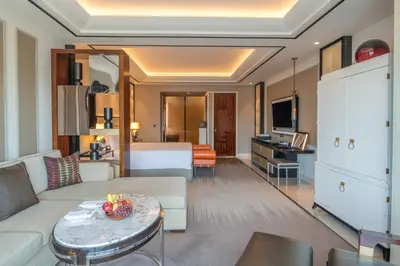 a hotel room with a couch and a bed at Solaire Resort Entertainment City in Manila
