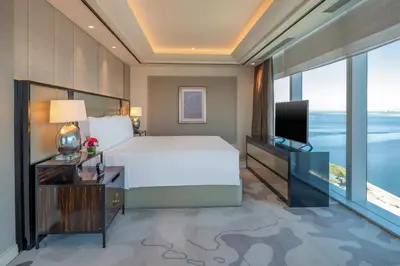 a bedroom with a large bed and a television at Solaire Resort Entertainment City in Manila