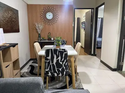 a dining room with a table and chairs at MaRoy Suites at Asteria Residences (Near NAIA with free Parking+Fiber Internet) in Manila