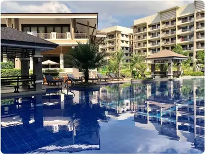 a swimming pool in front of a hotel at MaRoy Suites at Asteria Residences (Near NAIA with free Parking+Fiber Internet) in Manila