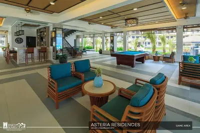 a lobby with couches and a pool table at MaRoy Suites at Asteria Residences (Near NAIA with free Parking+Fiber Internet) in Manila